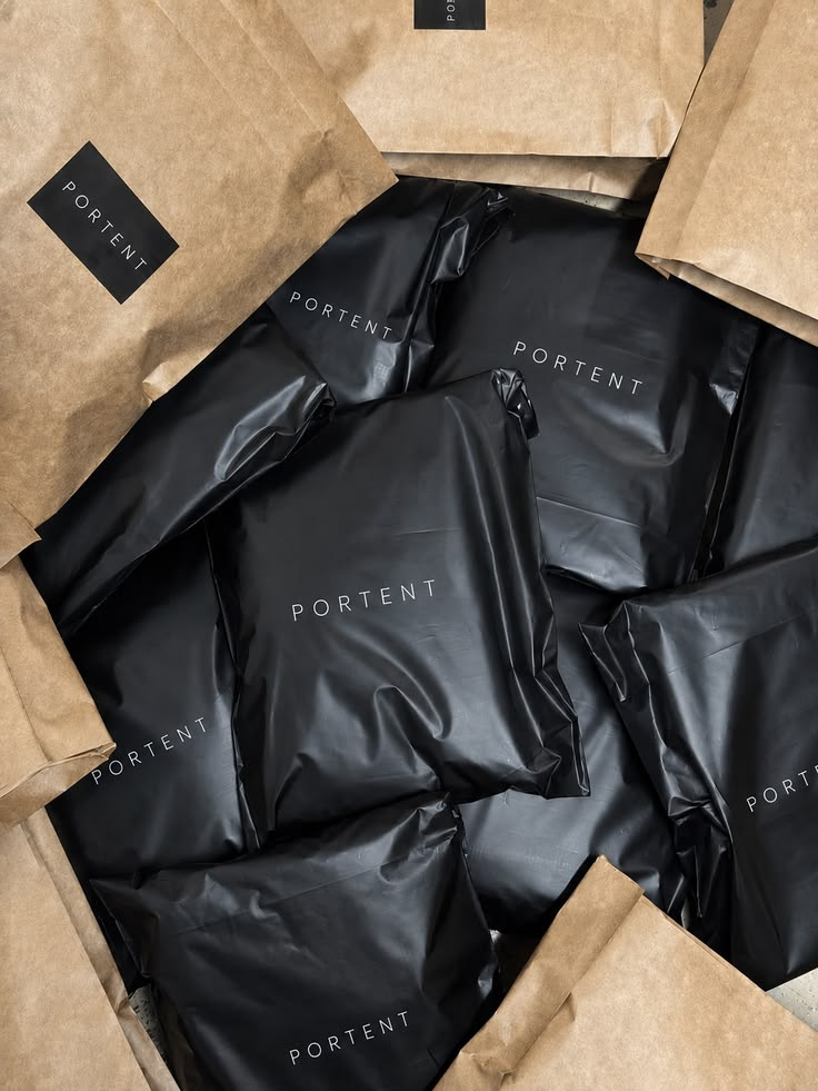 Black branded mailers and kraft paper bags