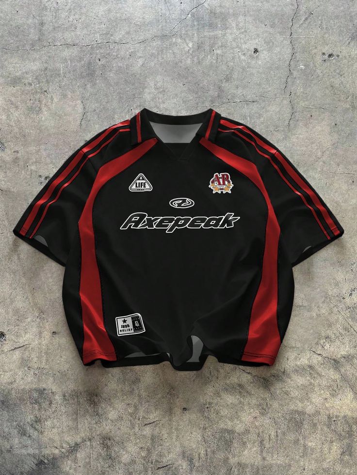 Black and red sports jersey laid flat on concrete